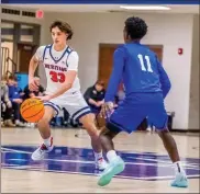  ?? Steven Eckoff, Rome News-tribune ?? Heritage’s Kaleb Biddle looks dribble past Model’s Stevie Dallas during a game at the Blue Blue Classic last week. The Generals will open region play Friday at home against CentralCar­roll.