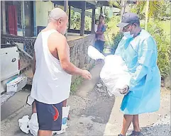  ?? Picture: ADRA ?? A resident receives food assistance from an ADRA volunteer.