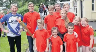  ??  ?? David Rutley MP with David Wilkinson, commercial director of Macclesfie­ld RUFC, and Beech Hall School pupils at their Olympic Torch Relay event