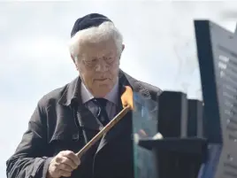  ?? Pictures: Neil McCartney ?? COMMITMENT. Survivor Lyonell Fliss lights a memorial lamp during Holocaust Remembranc­e Day in Joburg yesterday.