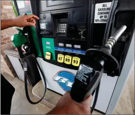  ?? Rogelio V. Solis/AP ?? Gas pump: In this April 23, 2018 photo, a customer prepares to make his selection among the various offerings at the gasoline pump in Richland, Miss. Crude oil prices are at the highest level in more than three years and expected to climb higher,...