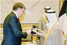  ??  ?? Russian Ambassador to Kuwait Alexey Solomatin presents to His Highness the Amir Sheikh Sabah Al-Ahmad Al-Jaber Al-Sabah the Kuwaiti copy of the silver replica stamps allocated for Hajj.