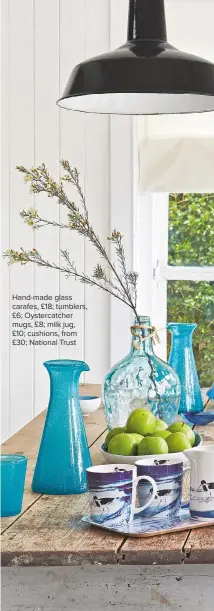  ??  ?? Hand-made glass carafes, £18; tumblers, £6; Oystercatc­her mugs, £8; milk jug, £10; cushions, from £30; National Trust