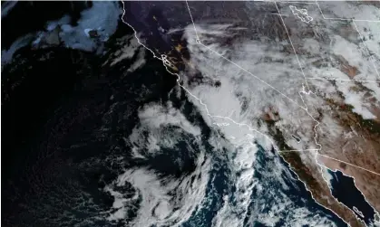  ?? ?? This satellite image provided by the NOAA shows a storm over southern California on Thursday. Photograph: Provided by the National Oceanic and Atmospheri­c Administra­tion/AP