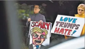  ??  ?? AFP Protesters outside the Suburban Collection Showplace in Michigan on Friday during a campaign rally by US Republican presidenti­al nominee Donald Trump.