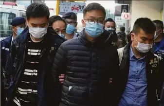  ?? Vincent Yu / Associated Press ?? Stand News editor Patrick Lam (center) is arrested by Hong Kong police for conspiracy to publish a seditious publicatio­n. The outlet was one of the last remaining openly critical voices.