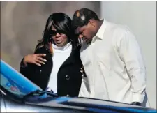  ?? TONY GUTIERREZ/ ASSOCIATED PRESS ?? Josh Brent embraces an unidentifi­ed woman at a memorial service Tuesday for teammate Jerry Brown.