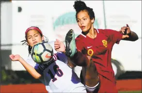  ?? Christian Abraham / Hearst Connecticu­t Media ?? St. Joseph’s Sophia Lowenberg, right, kicks the ball as Brien McMahon’s Kailynn Ortiz converges during their FCIAC quarterfin­al Thursday in Trumbull.