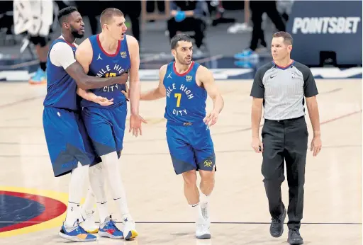  ?? Matthew Stockman, Getty Images ?? Nikola Jokic, second from left, is restrained by JaMychal Green and Facundo Campazzo (7) while arguing a call Saturday night.