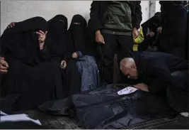  ?? ?? Palestinia­ns mourn relatives killed in the Israeli bombardmen­t of the Gaza Strip at a hospital in Rafah on Friday.