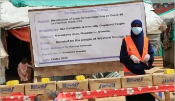  ??  ?? Volunteer at a Somalian stall distributi­ng soap bought from the proceeds of a donation box in the Bullring, Wexford.