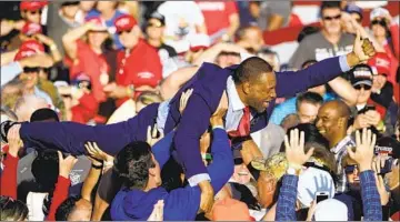  ?? GEORGIA STATE John Bazemore Associated Press ?? Rep. Vernon Jones crowd- surfs during an October campaign rally for President Trump.