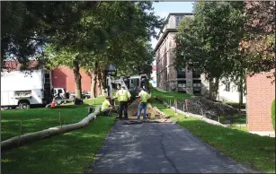  ?? Ernest A. Brown photo ?? Workers are busy working on a trench on what will be a portion of the Blackstone Valley Bikeway between Vintage Restaurant and Hanora Lippitt Manor, connecting the bikepath between the Truman Bypass and Market Square.