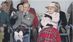  ??  ?? 0 The Queen and Prince Philip at the Braemar Gathering in 2013