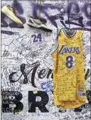  ?? AP file photo ?? Sneakers and a Los Angeles Lakers uniform with a number worn by NBA star Kobe Bryant are left at a memorial for Bryant near Staples Center on Feb. 2.