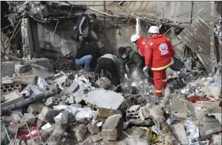  ?? MOHAMMED ZAATARI -THE ASSOCIATED PRESS ?? Workers search for victims in the rubble of a paramedic center that was destroyed by an Israeli airstrike early Wednesday in Hebbariye village, south Lebanon. The Israeli airstrike was one of the deadliest single attacks since violence erupted along the Lebanon-Israel border.