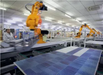  ?? ?? Workers produce photovolta­ic (PV) modules for export in the workshop of a PV company in Dongying, Shandong Province, on February 24, 2023