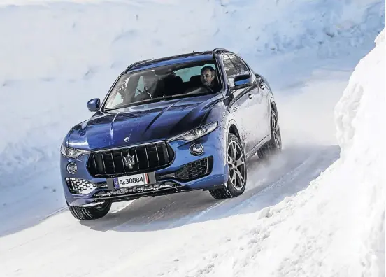  ??  ?? Putting the Maserati Levante S to the test on an icy go-kart track.