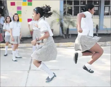  ?? Pedro Pardo
AFP/Getty Images ?? STUDENTS play at recess in Acapulco, Mexico. U.S.-born children whose families return to Mexico risk becoming left behind in school, their culture shock compounded by their lack of fluency in Spanish.