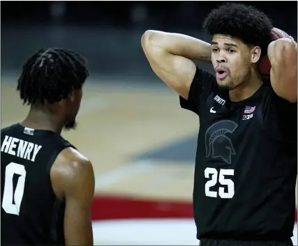  ?? JULIO CORTEZ PHOTOS — THE ASSOCIATED PRESS ?? Michigan State’s Malik Hall, right, reacts after being called for a foul as teammate Aaron Henry looks on during Sunday’s loss to Maryland.