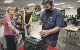  ?? NICK SABALLOS Dania Maxwell Los Angeles Times ?? shreds a denial letter, a ritual at the rejection party. Students also announce which college they’ll attend and celebrate with ice cream sundaes.