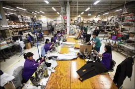  ?? ASSOCIATED PRESS 2013 ?? Workers manufactur­e car dash mats at a factory belonging to the TECMA group in Ciudad Juarez, Mexico. President Donald Trump’s vow to scrap or revamp NAFTA was expected to put a scare into companies considerin­g moving south.