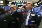  ?? RICHARD DREW — THE ASSOCIATED PRESS FILE ?? In this file photo, traders Eric Schumacher, left, and Richard Deviccaro work on the floor of the New York Stock Exchange. Wall Street capped a day of volatile trading with a late-afternoon buying spree that sent U.S. stock indexes to a mostly higher finish Friday.