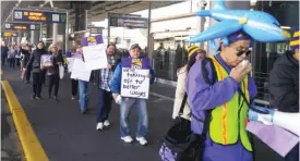  ?? | JESSE BETEND/ FOR THE SUN- TIMES ?? Striking workers at O’Hare last year; a new deal may ensure labor peace at the airport and allow 8,000 employees to join unions.