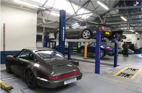  ??  ?? All generation­s of Porsche arrive at Charles Ivey for servicing. The 968 on the ramp represents an upturn in servicing and restoratio­n on frontengin­ed Porsches, as values have started to climb