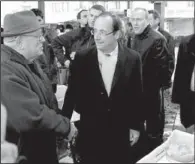  ?? AP/BOB EDME ?? French Socialist Party candidate Francois Hollande (right) campaigns Saturday in a market in Tulle.