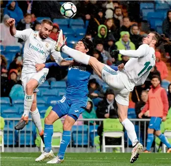  ?? AFP ?? Gareth Bale (right) and Dani Carvajal (left) of Real Madrid vie with Gaku Shibasaki of Getafe during their Spanish league match at the Santiago Bernabeu stadium in Madrid on Saturday. —