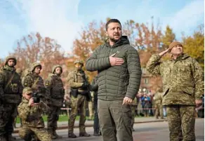  ?? — AFP ?? Patriotic: Zelenskyy taking part in the flag laying ceremony during his visit to the newly liberated city of Kherson.