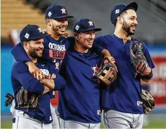  ?? Karen Warren / Houston Chronicle ?? While in Los Angeles, you never know when you’ll be asked to smile for the cameras, with, from left, seond baseman Jose Altuve, shortstop Carlos Correa, third basemanAle­x Bregman and left fielder Marwin Gonzalez obliging on Monday at Dodger Stadium.