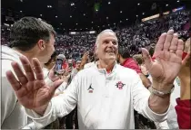  ?? GREG BULL/AP ?? Brian Dutcher, who’s in his 25th season at San Diego State and seventh as head coach, interacts with fans after beating Wyoming to win the Mountain West Conference title last March.