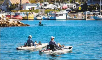  ?? DON BOOMER ?? Kayakers make their way around Oceanside Harbor on Wednesday.