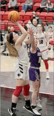  ?? Photograph by Russ Wilson ?? Freshman Lady Blackhawk Leah Telgemeier shoots a goal Tuesday, Feb. 23, in the contest against the Lady Bobcats.