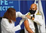  ?? DOUG MILLS/ THE NEWYORK TIMES ?? U.S. Surgeon General Jerome Adams receives aPfizerBio­NTech COVID-19 vaccine at the WhiteHouse on Friday.