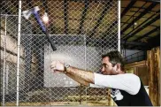  ?? NICK GRAHAM / STAFF ?? Marty Parker with Cincinnati Axe Throwing demonstrat­es how to throw an ax. A venue that includes ax throwing is planned for the Fire Blocks District.