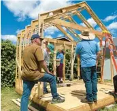  ?? LISA KOGAN/AMIKAS ?? Community members come together to help build cabins for mothers with children on property owned by Meridian Baptist Church in El Cajon, California.