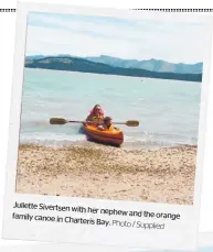  ?? Photo / Supplied ?? Juliette Sivertsen with her nephew and the orange family canoe in Charteris
Bay.