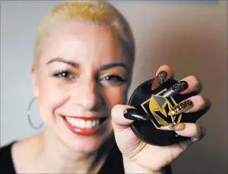  ?? K.M. Cannon ?? Las Vegas Review-journal @Kmcannonph­oto Andrea Lipomi, owner of Feetish Spa Parlor, shows her Vegas Golden Knights-themed nails at her downtown salon Tuesday.