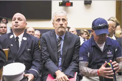  ?? Zach Gibson / Getty Images ?? Former Daily Show host Jon Stewart, center, sits with others before testifying during a House Judiciary Committee hearing on Tuesday in Washington, D.C., on reauthoriz­ation of the September 11th Victim Compensati­on Fund. The fund provides financial assistance to responders, victims and their families for medical care related to health issues they suffered in the aftermath of the 9/11 terrorist attacks.