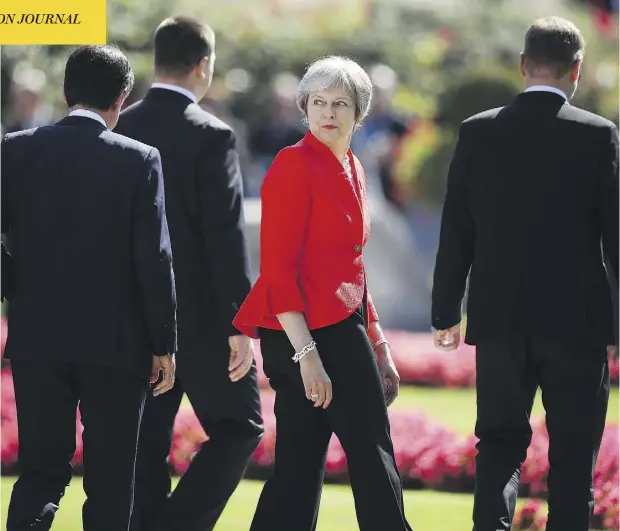  ?? SEAN GALLUP / GETTY IMAGES ?? British Prime Minister Theresa May and other European leaders leave a photo session on the second day of a summit in Salzburg, Austria.