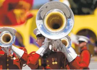  ?? ?? The U.S. Marine Drum and Bugle Corps performs at the centennial celebratio­n on Saturday. The Marine Corps Recruit Depot trains recruits from all areas west of the Mississipp­i.
