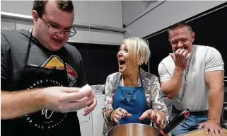  ?? Kim Brent / Staff photograph­er ?? Honey Staudenmie­r and Russell Watley laugh as Paul Deslatte accidental­ly sprays egg on a team member. Staudenmie­r has spent years doing paraprofes­sional life skills training.