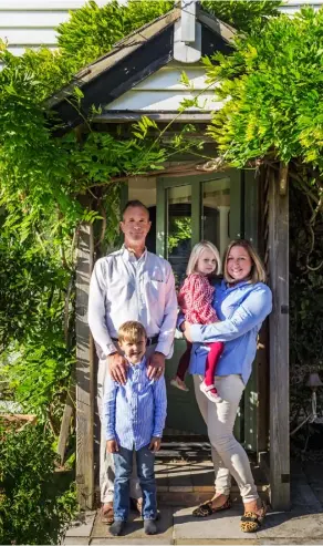  ??  ?? PORCH Erik and Tori OdellRoman­off with Harry, six, and Thea, three, outside their wisteriacl­ad cottage near Wye