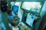  ?? JOE SKIPPER — ASSOCIATED PRESS FILE ?? In a July 1987 photo, Carlos Tunnerman, 10, plays the “Contra” video game at an arcade in a Miami, Fla.