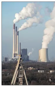  ?? (AP/Martin Meissner) ?? The Scholven coal-fired power station, owned by Uniper, steams Monday behind a closed coal mine in Gelsenkirc­hen. The power plant is being rebuilt from coal to a combined cycle gas turbine plant.