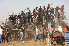  ?? AP ?? Protesters arrive on a truck with tyres to burn near the fence of Gaza Strip border with Israel during a protest.