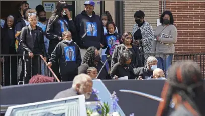  ?? Emily Matthews/Post-Gazette ?? Friends and family of Jaiden Brown, one of the 17-year-old victims of the mass shooting on the North Side, walk out of Living Water Ministry at the end of his funeral service on April 22 in Braddock.